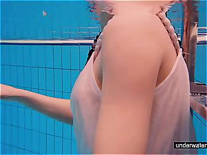 nubile lady Avenna is swimming in the pool